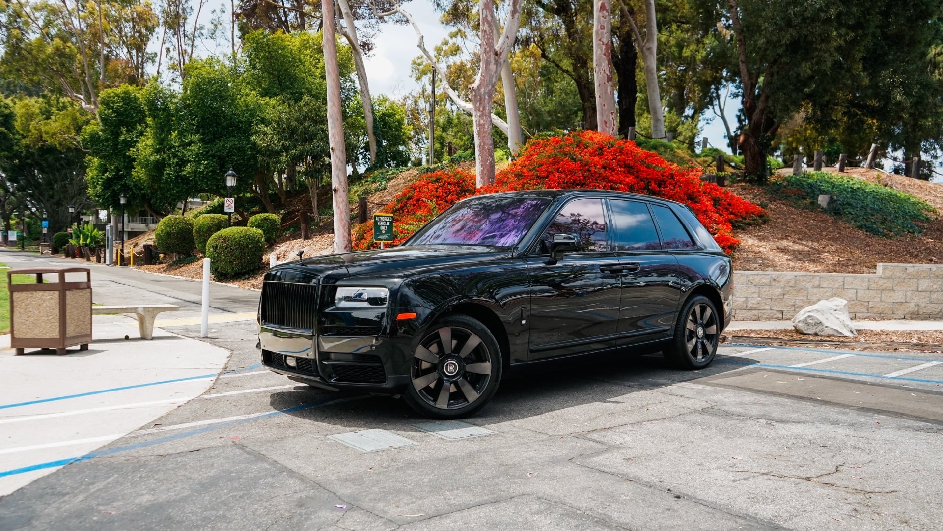 Black Rolls-Royce Cullinan with red interior for a red carpet awards season arrival in Los Angeles